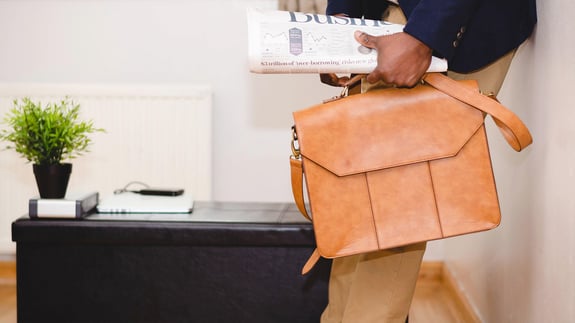 Man with newspaper and messenger bag